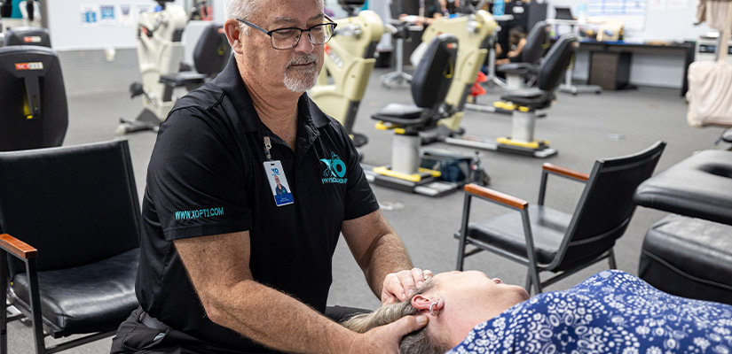 XO Physical Therapy: therapist doing treatment. Therapy on neck, providing relief during his vertigo treatment.