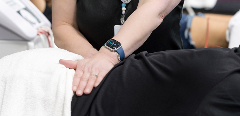 Individual undergoing non-surgical spinal decompression therapy in a calming massage room setting. XO physical therapy in South Texas.