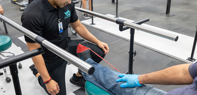 A man receives a leg examination from a XO Physical therapist, highlighting expert physical therapy advice for South Texas runners.