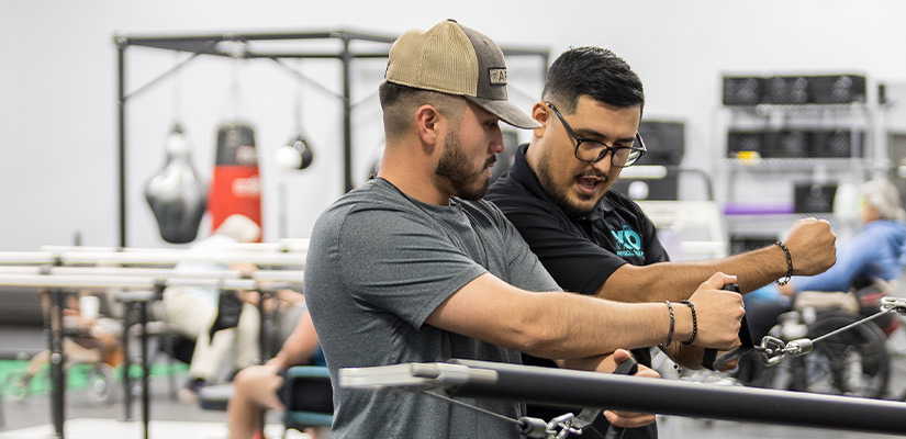 Young man and physical therapist doing exercises at XO physical therapy South Texas