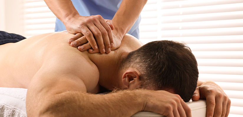 A man enjoying a massage in a serene room, aimed at alleviating neck pain in McAllen.